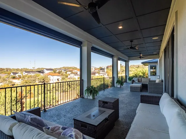 a balcony with furniture and a floor to ceiling window
