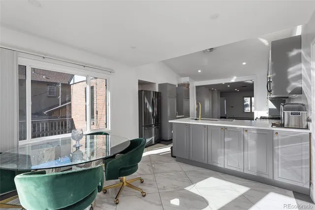 a large kitchen with stainless steel appliances granite countertop a sink and a stove