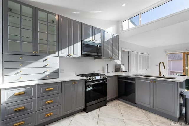 a kitchen with stainless steel appliances granite countertop a sink and a stove