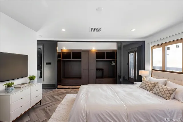 a bedroom with a bed and a flat screen tv
