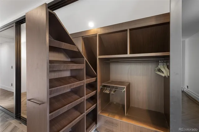 a view of walk in closet with empty racks