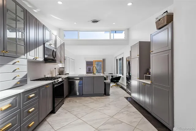 a kitchen with granite countertop stainless steel appliances and wooden cabinets