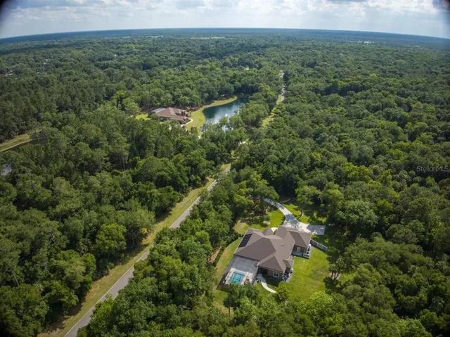 an aerial view of a house with a yard