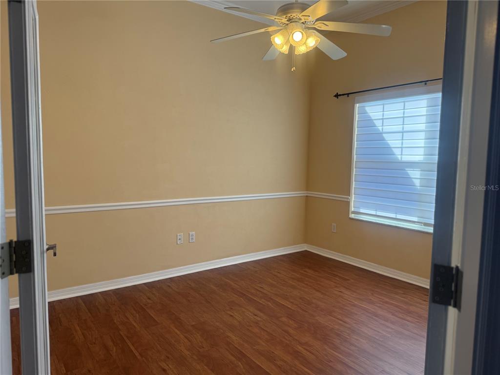 10054 Southwest 98th Avenue Gainesville, FL 32608 - Photo 6 of 14 an empty room with wooden floor and windows