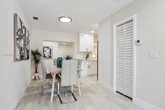 a dining room with furniture and wooden floor