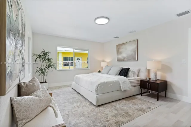 a spacious bedroom with a bed and a couch