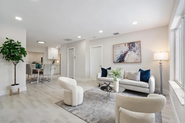 a living room with furniture and a potted plant