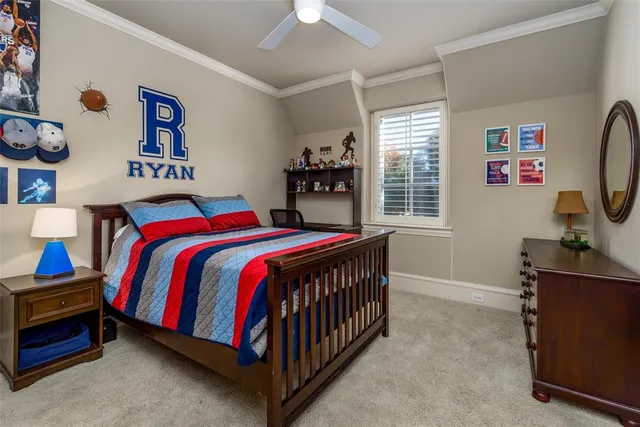 a bedroom with a bed and a flat tv screen on dresser
