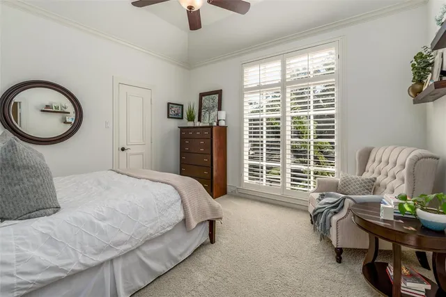 a bedroom with a bed a couch and a chandelier