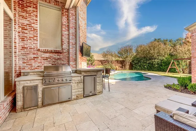 a open kitchen with granite countertop a sink and a stove