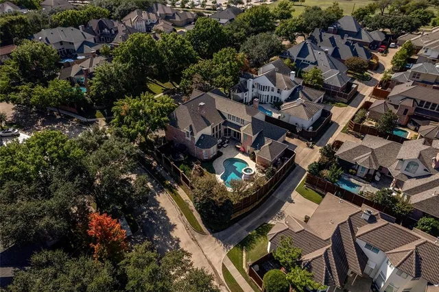 an aerial view of residential houses with outdoor space