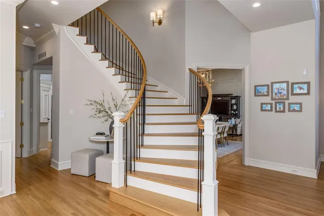 a view of entryway and hall with wooden floor