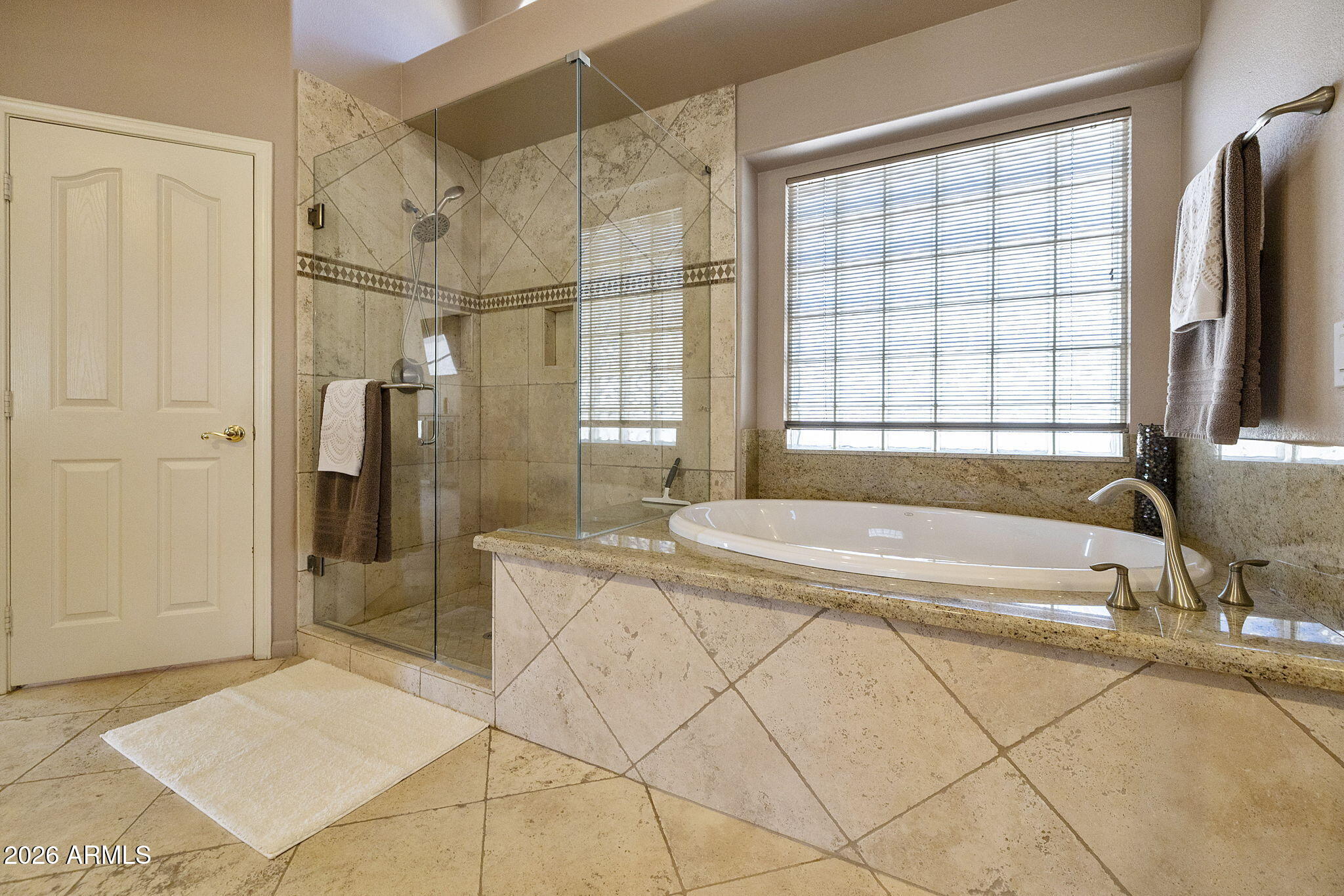 12435 West Monte Vista Road Avondale, AZ 85392 - Photo 41 of 69 a spacious bathroom with a bathtub and a shower