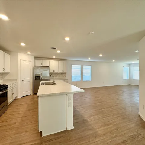 a kitchen with a sink stainless steel appliances and cabinets