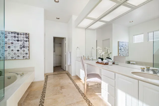 a spacious bathroom with a bathtub sink and mirror