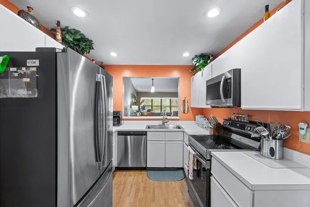 a kitchen with stainless steel appliances a sink stove and refrigerator