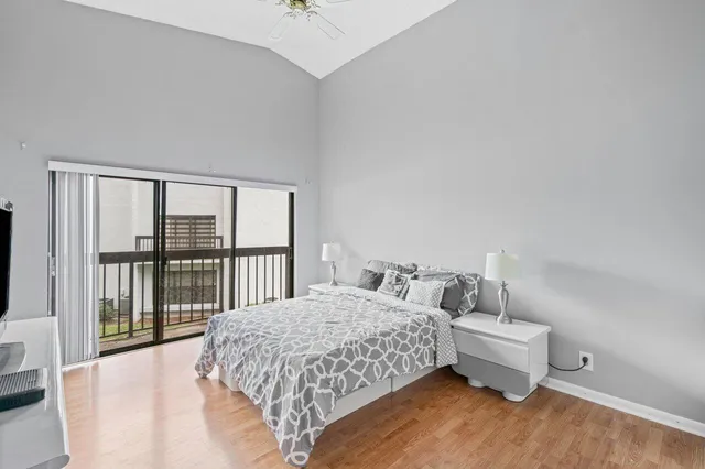 a bedroom with a bed and a large window