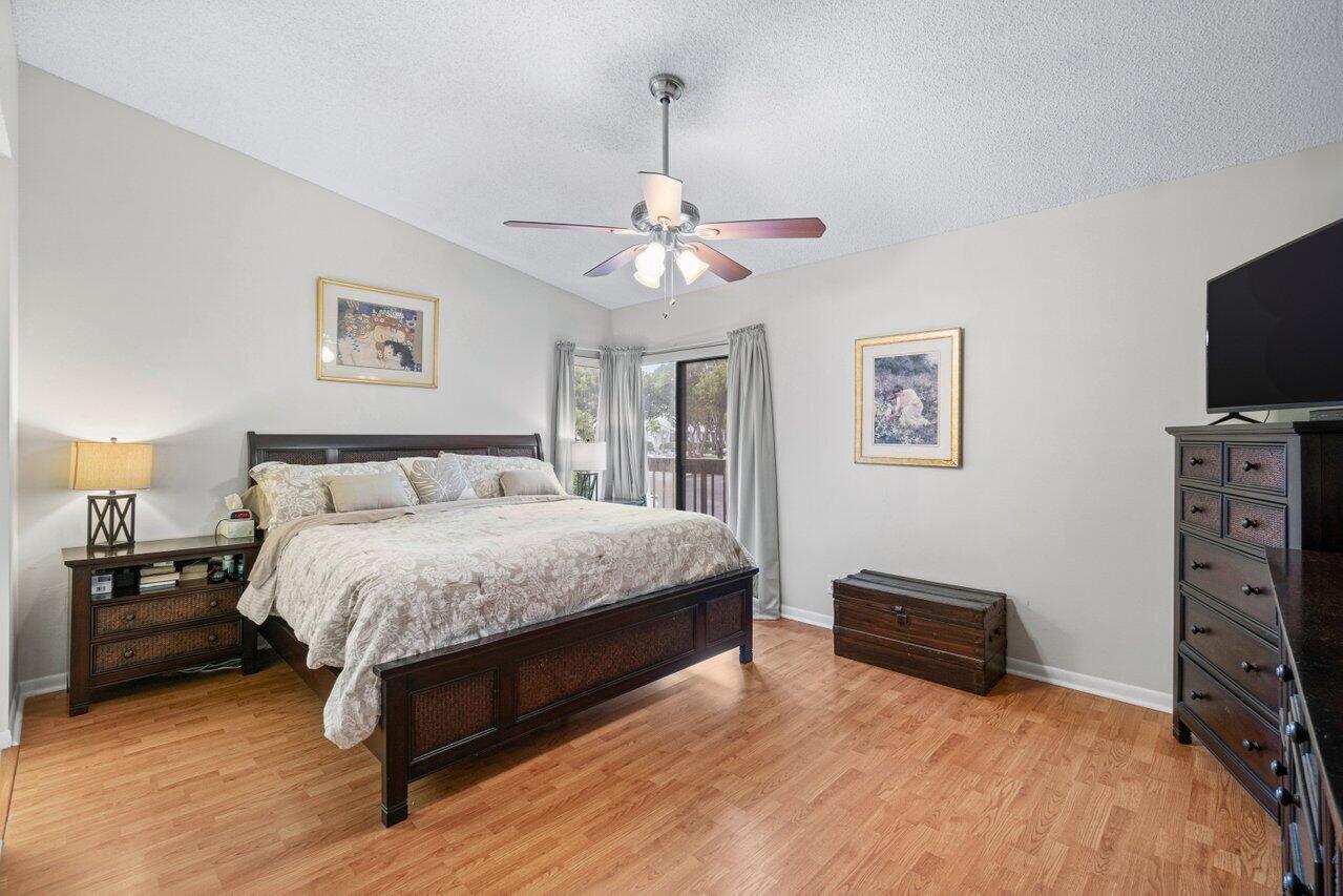 5020 Golfview Court, Unit 1426 Delray Beach, FL 33484 - Photo 3 of 50 a spacious bedroom with a bed and a flat screen tv