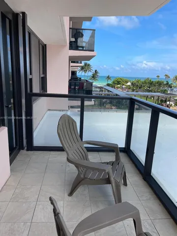 a balcony with furniture and a potted plant