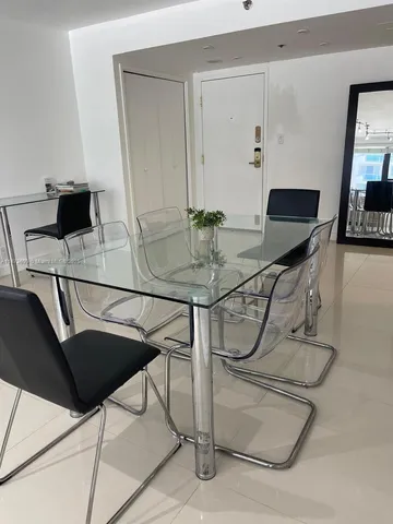 a view of a workspace with a table and chairs