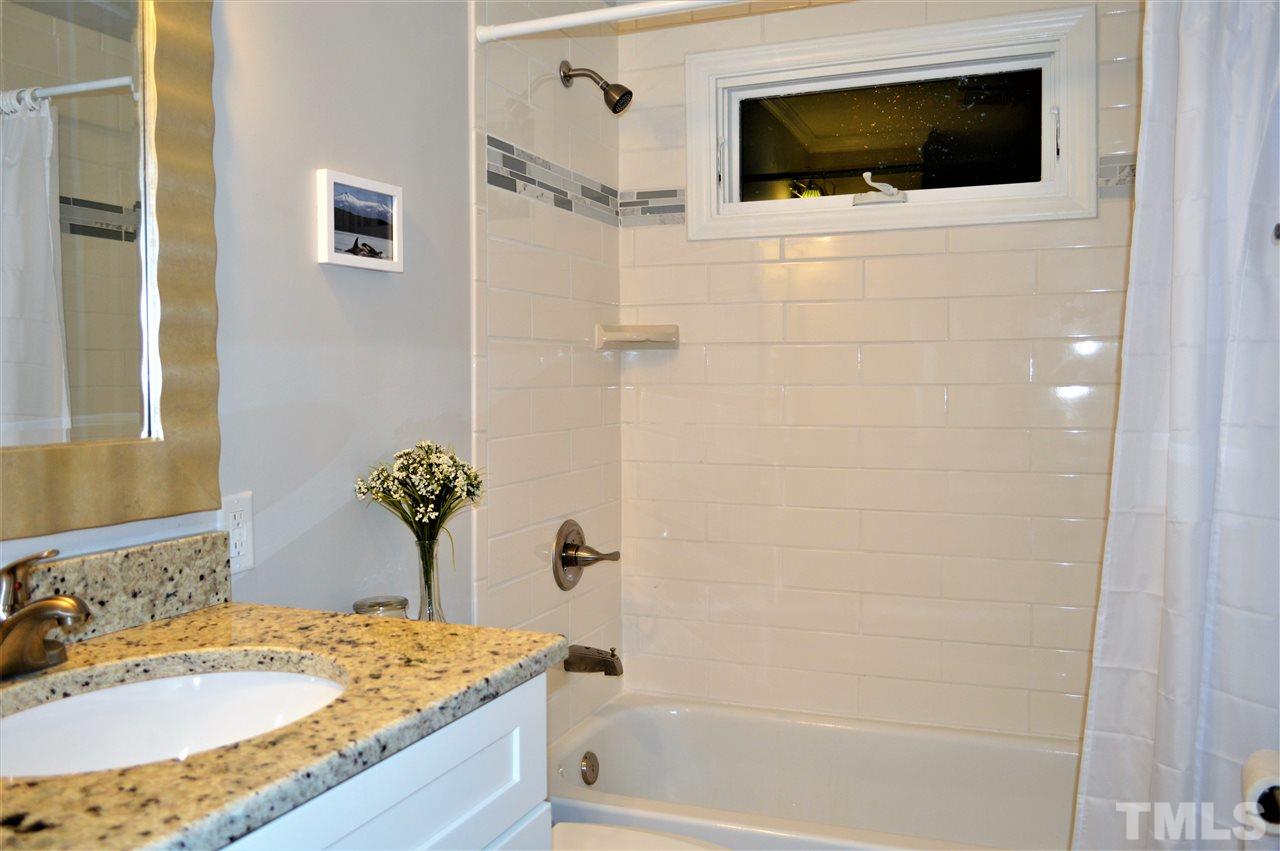 2387 Stevens Road Raleigh, NC 27610 - Photo 12 of 25 a bathroom with a granite countertop sink a mirror and shower