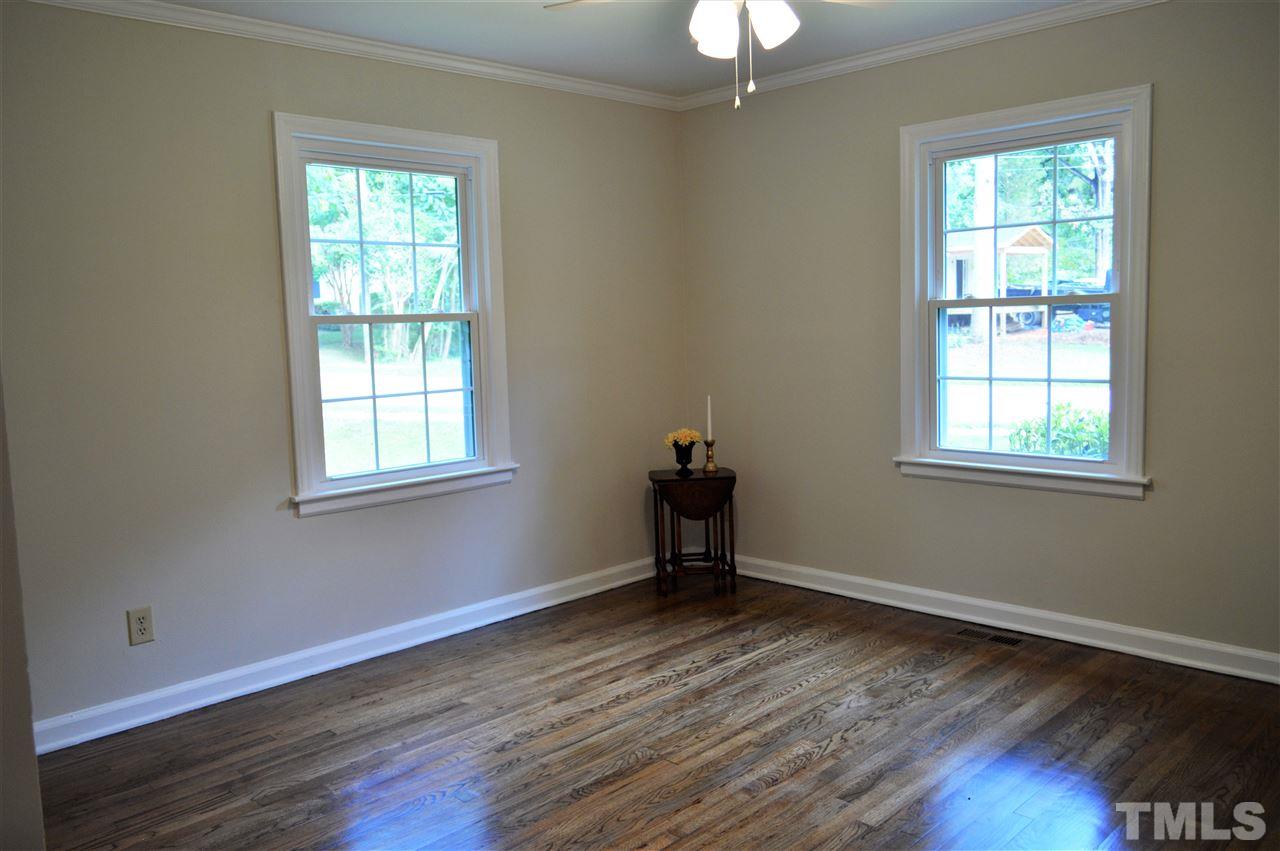 2387 Stevens Road Raleigh, NC 27610 - Photo 14 of 25 a view of an empty room with wooden floor and a window
