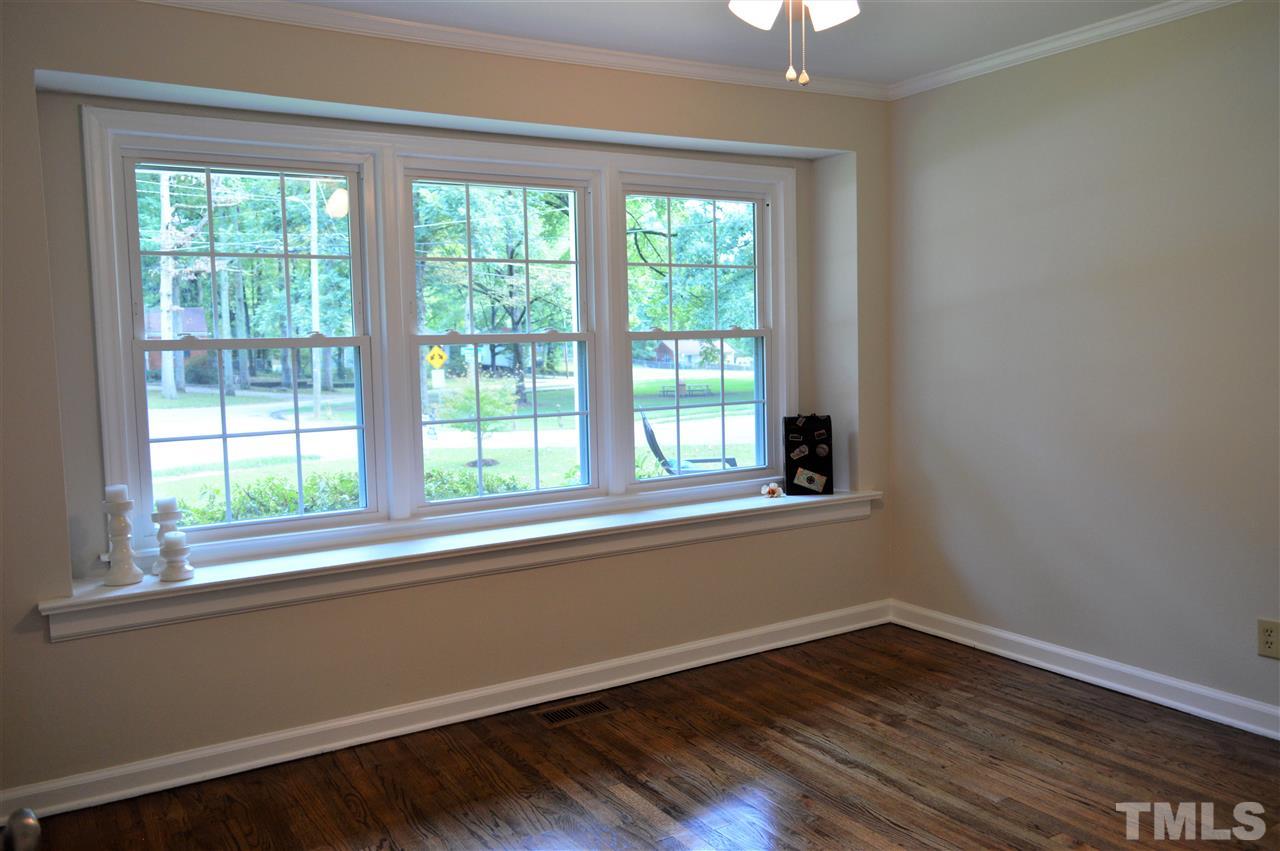 2387 Stevens Road Raleigh, NC 27610 - Photo 15 of 25 a view of an empty room with wooden floor and a window