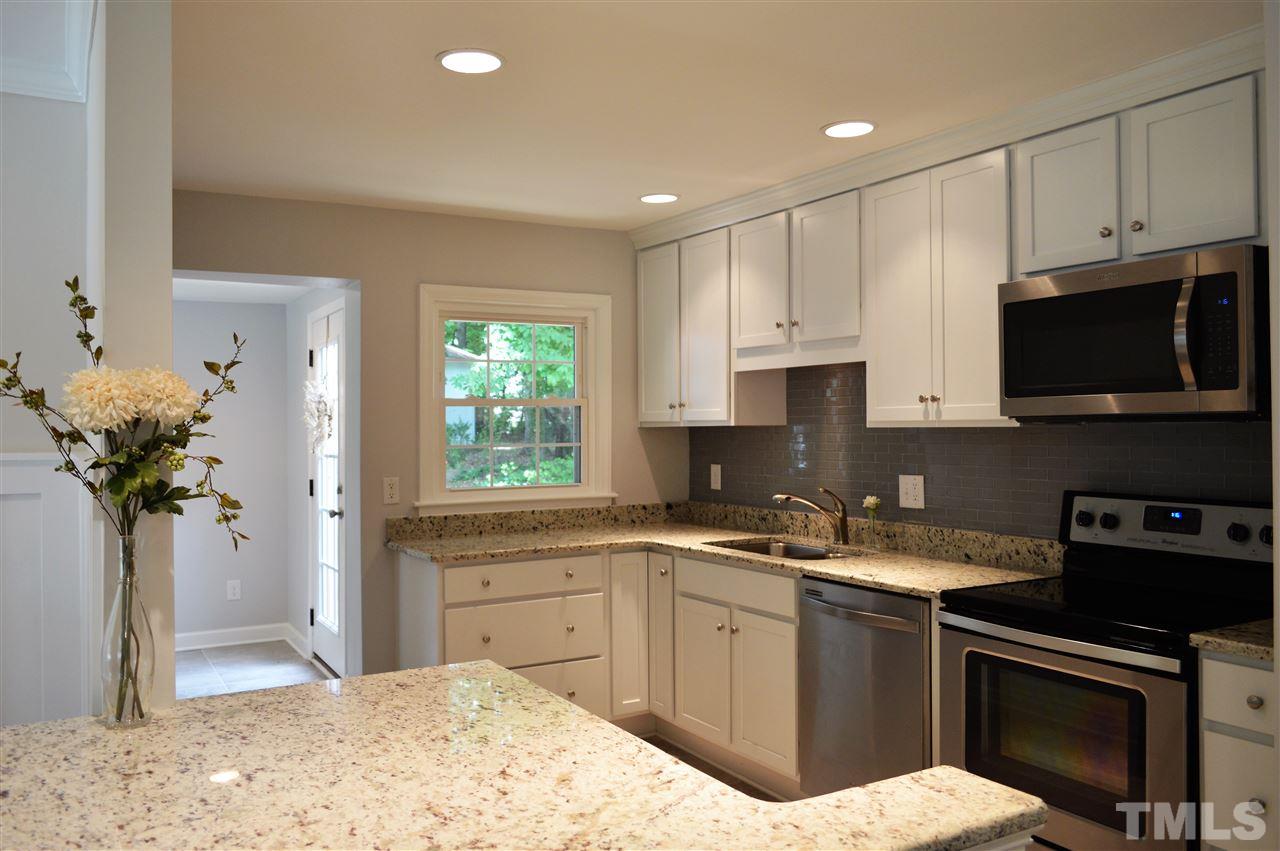 2387 Stevens Road Raleigh, NC 27610 - Photo 5 of 25 a kitchen with a sink a stove and cabinets