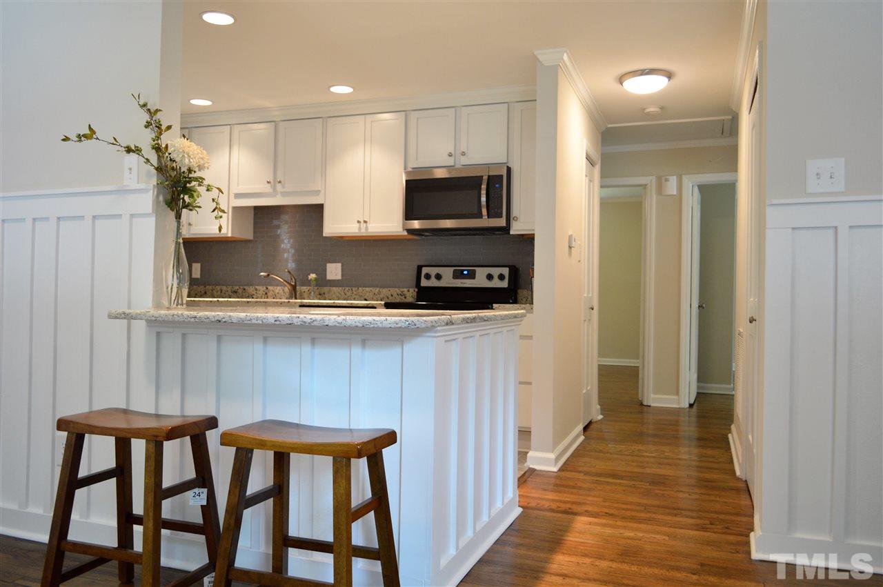 2387 Stevens Road Raleigh, NC 27610 - Photo 6 of 25 a kitchen with stainless steel appliances kitchen island granite countertop a sink and a refrigerator