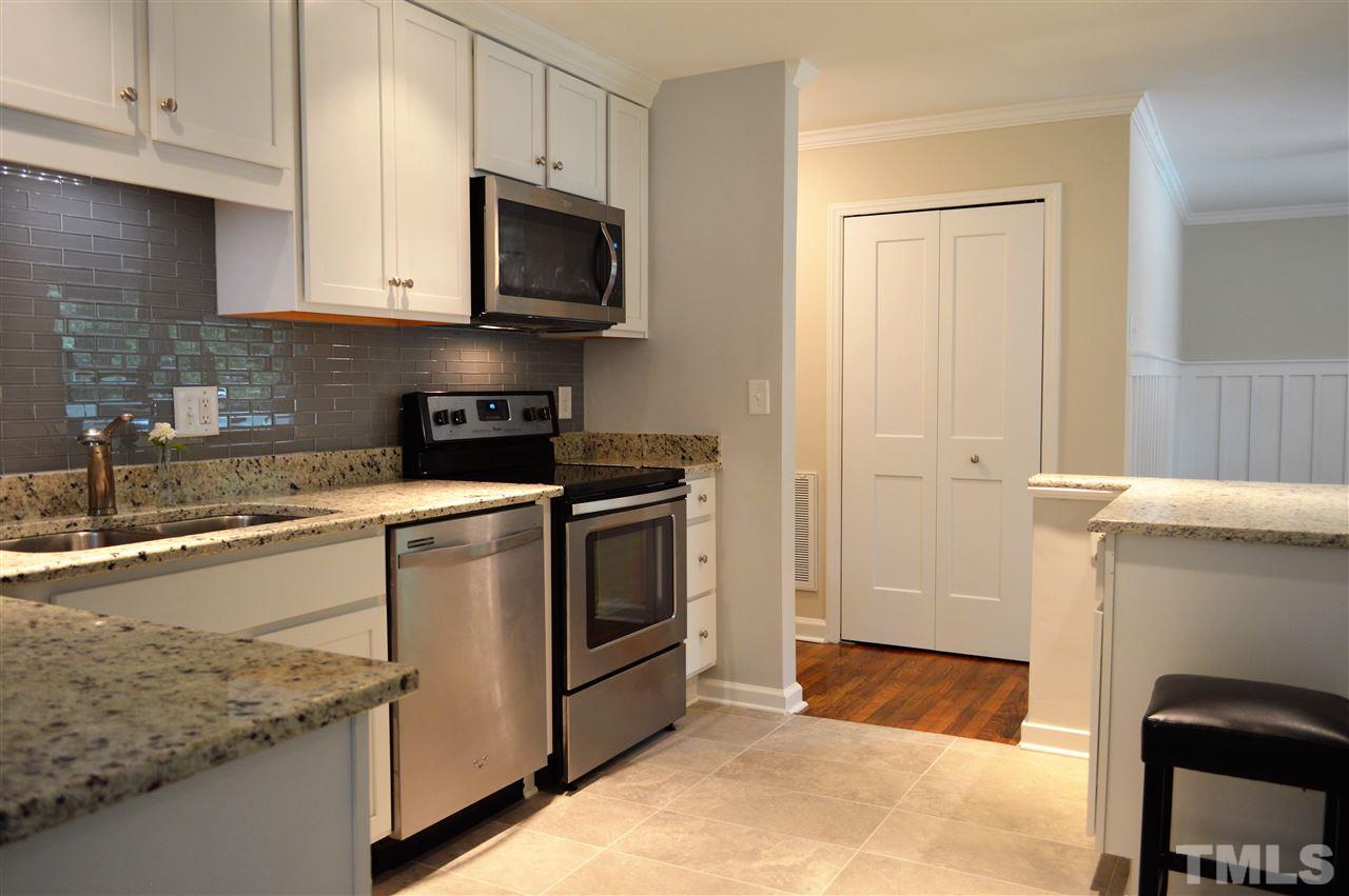 2387 Stevens Road Raleigh, NC 27610 - Photo 7 of 25 a kitchen with granite countertop a sink a stove and cabinets