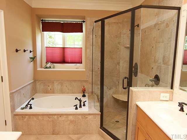 3004 Wyntree Ridge Way Raleigh, NC 27606 - Photo 15 of 25 Jacuzzi tub and separate shower complete this spa bathroom. Lovely tile work.