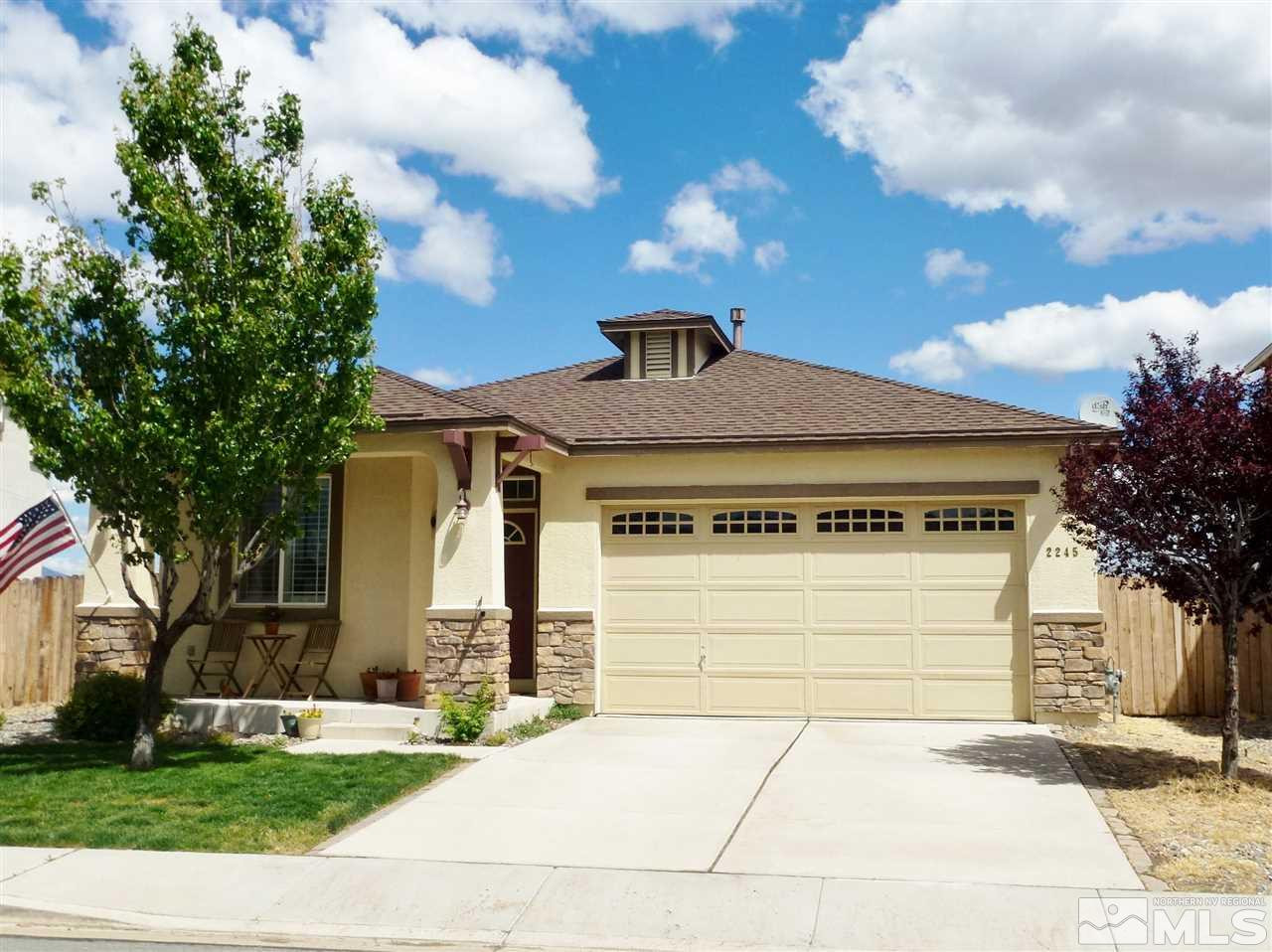 2245 Big Trail Circle Reno, NV 89521 - Photo 1 of 1 a front view of a house with a yard and garage
