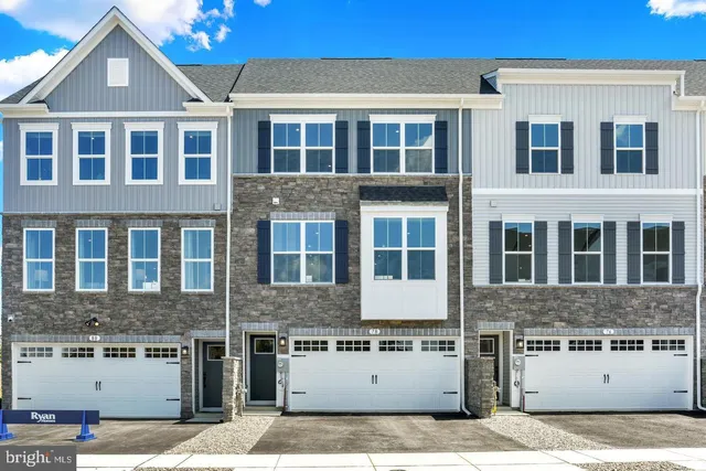 a front view of a building with a garden