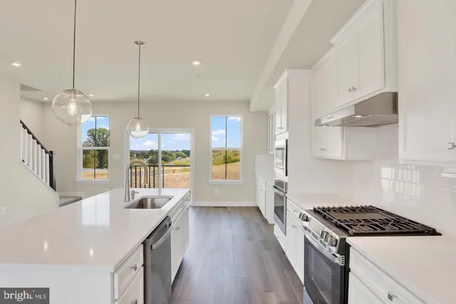 a kitchen with counter top space and wooden floor