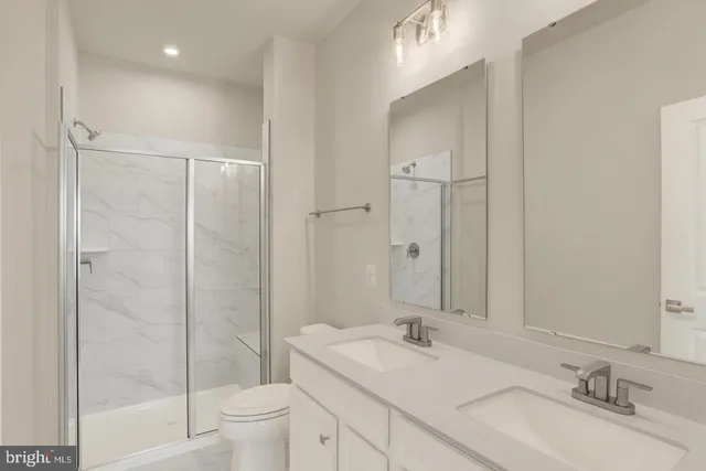 a bathroom with a double vanity sink and mirror