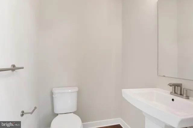 a white toilet sitting next to a white sink