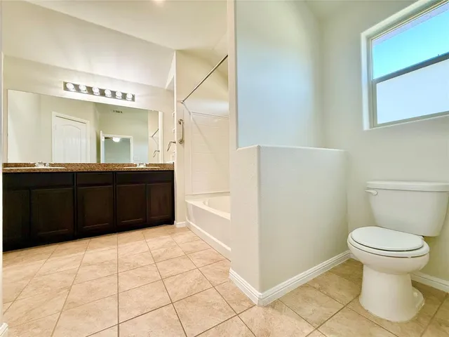 a view of a livingroom with wooden floor and a ceiling fan