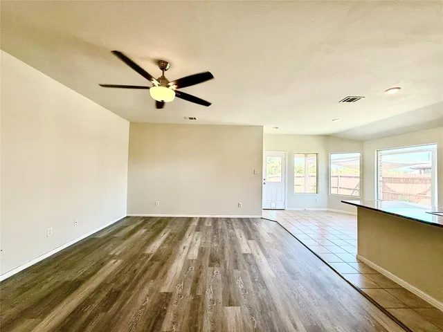 a kitchen with stainless steel appliances kitchen island granite countertop a refrigerator and a stove top oven