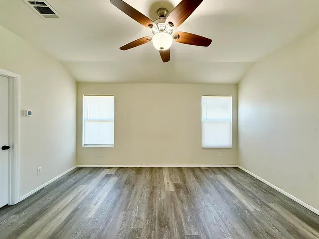 a large kitchen with stainless steel appliances kitchen island granite countertop a refrigerator and a stove top oven