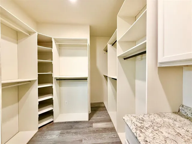 a large kitchen with a large counter top appliances and cabinets