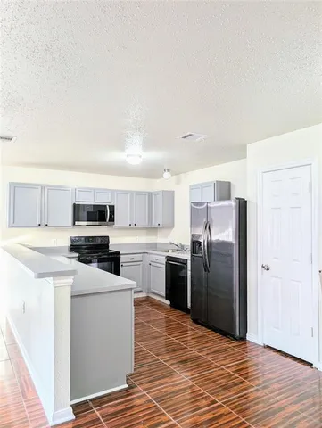a kitchen with stainless steel appliances a refrigerator sink and stove