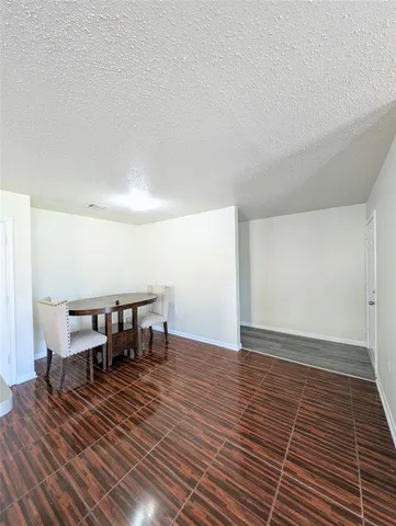 a view of a room that has a table and chairs in it