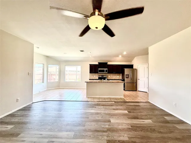 a kitchen with stainless steel appliances granite countertop a refrigerator sink and stove