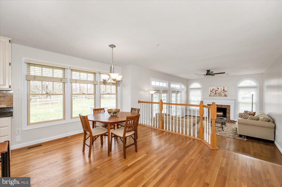 17900 Hickman Street Poolesville, MD 20837 - Photo 22 of 97 a view of a dining room with furniture and wooden floor