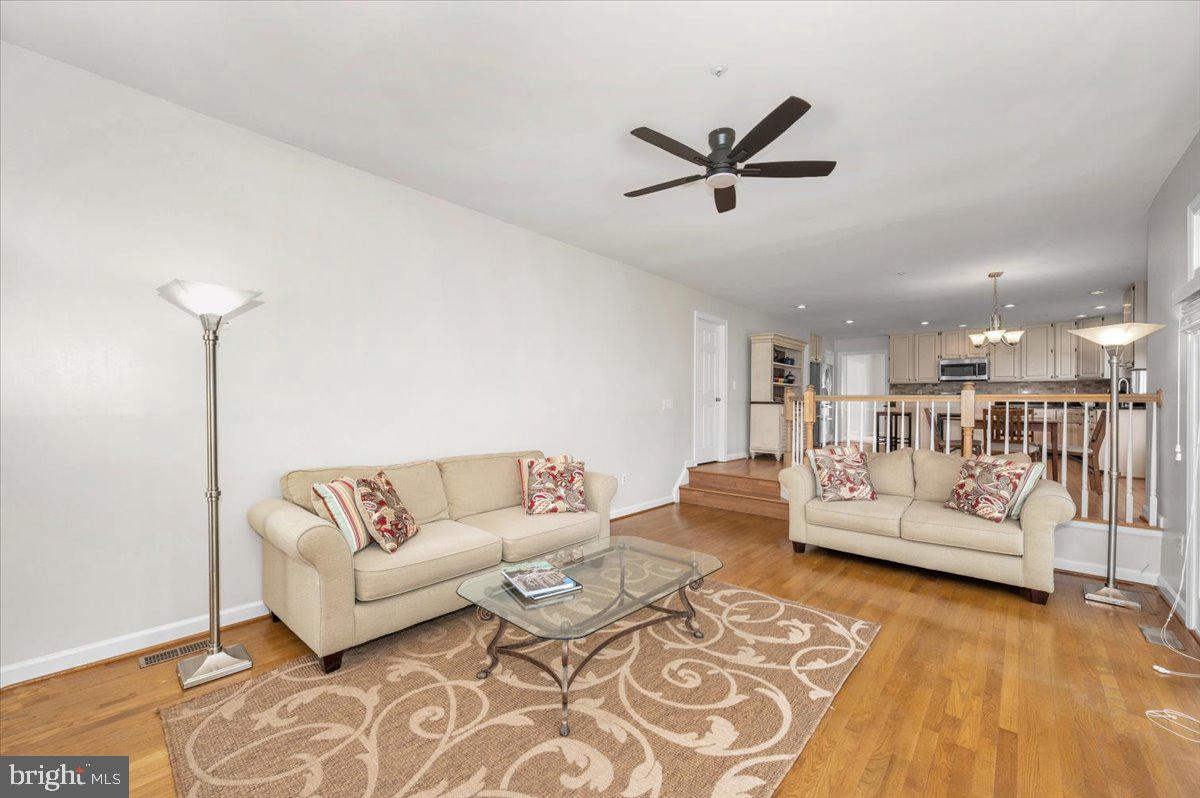 17900 Hickman Street Poolesville, MD 20837 - Photo 27 of 97 a living room with furniture and a wooden floor