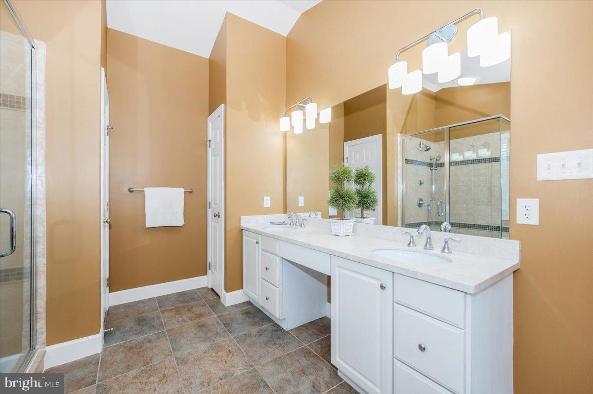 17900 Hickman Street Poolesville, MD 20837 - Photo 39 of 97 a bathroom with a double vanity sink and a mirror