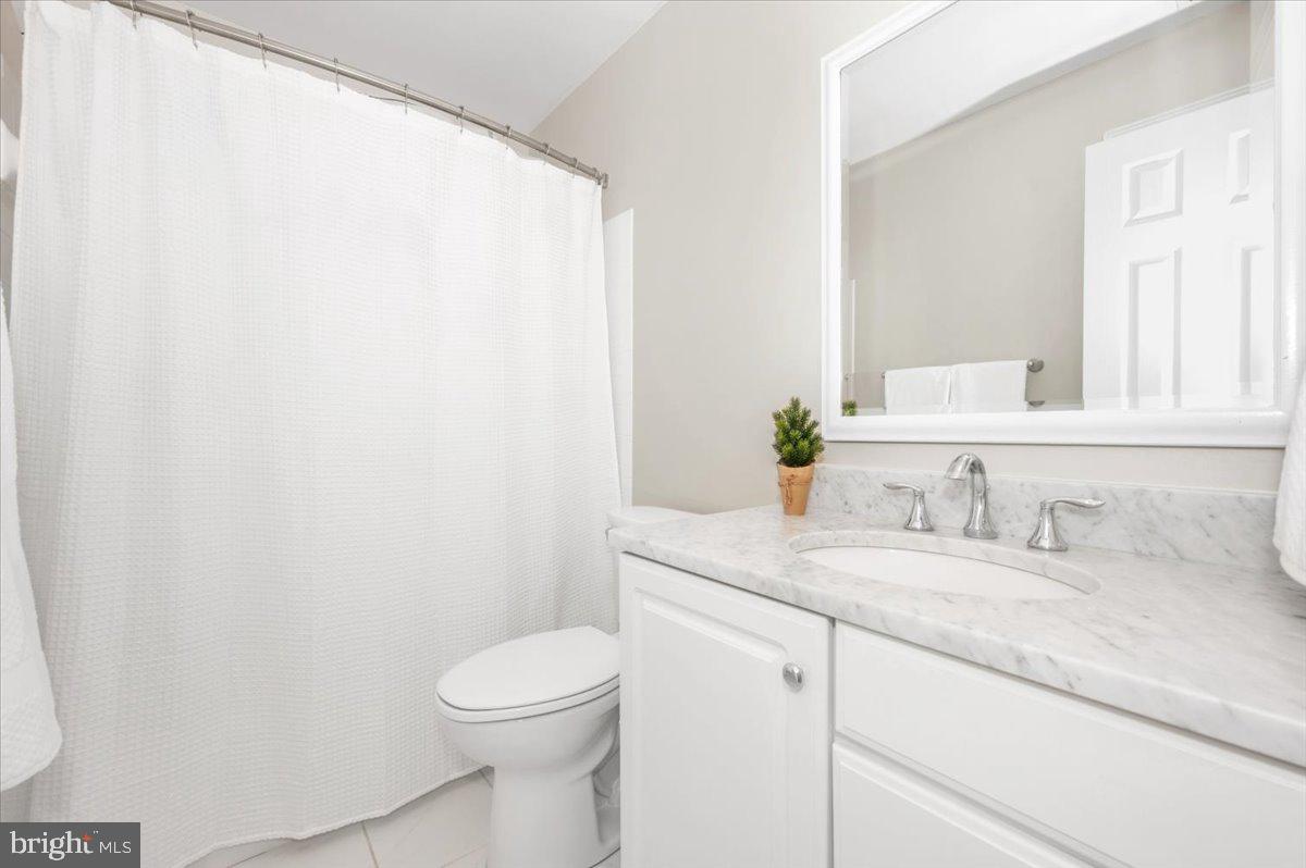 17900 Hickman Street Poolesville, MD 20837 - Photo 43 of 97 a bathroom with a granite countertop sink and a toilet