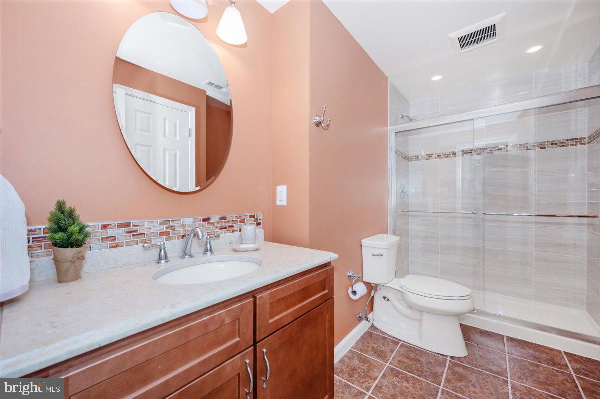 17900 Hickman Street Poolesville, MD 20837 - Photo 53 of 97 a bathroom with a sink a toilet and a mirror