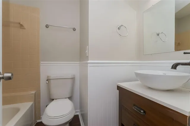 a bathroom with a toilet a sink and bathtub