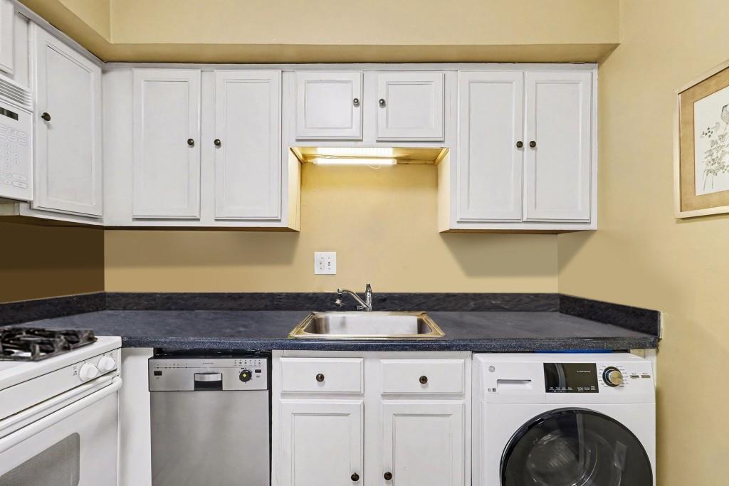 2477 North Decatur Road, Unit A1 Decatur, GA 30033 - Photo 15 of 29 a kitchen with granite countertop white cabinets and white appliances